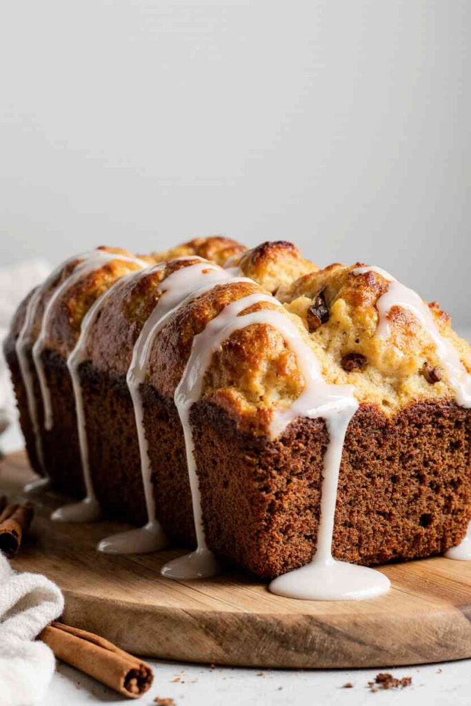 Homemade Amish Apple Fritter Bread with glaze, sliced on a rustic table