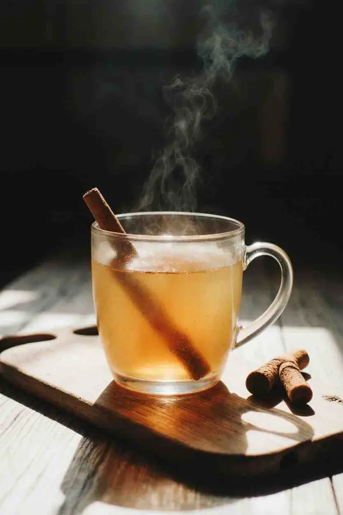 turmeric tea recipe served in a mug with steam and cozy background